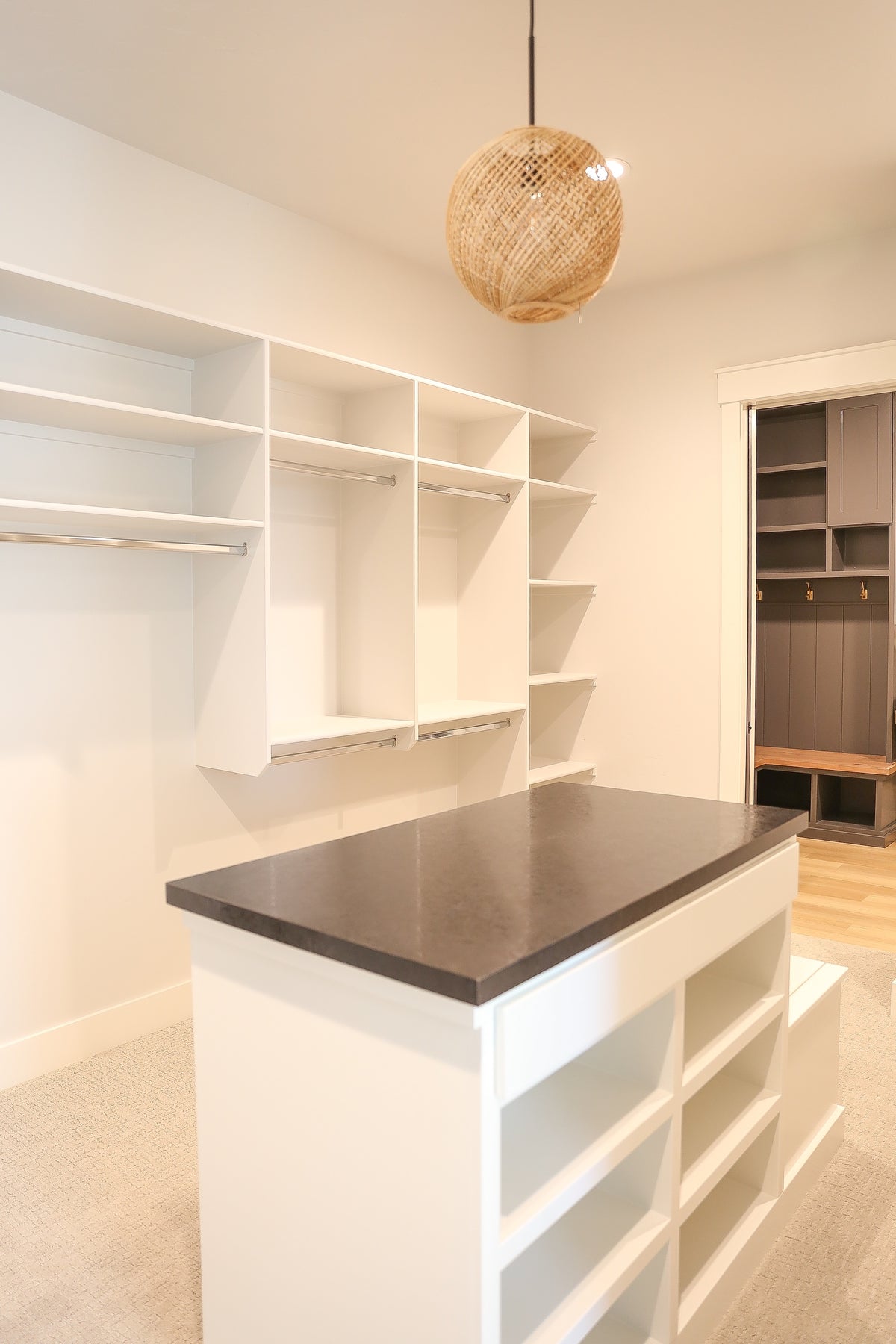 Modern kitchen with white cabinets, a countertop, and a pendant light.
