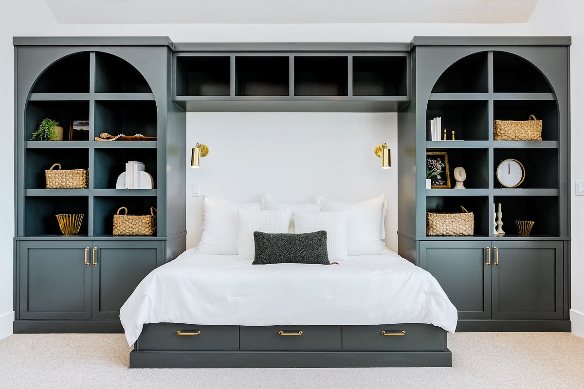 Bedroom with built-in bookshelves and bed