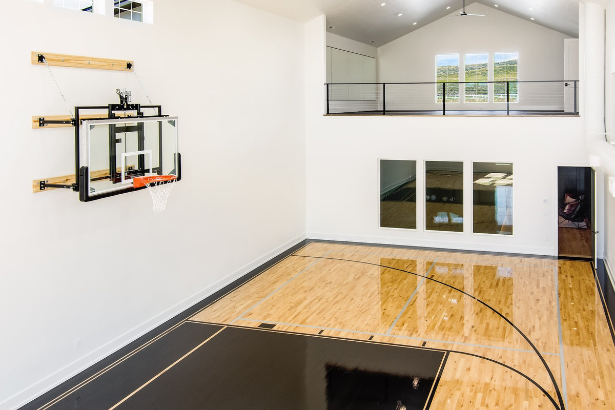Indoor basketball court with hoop in a modern home setting