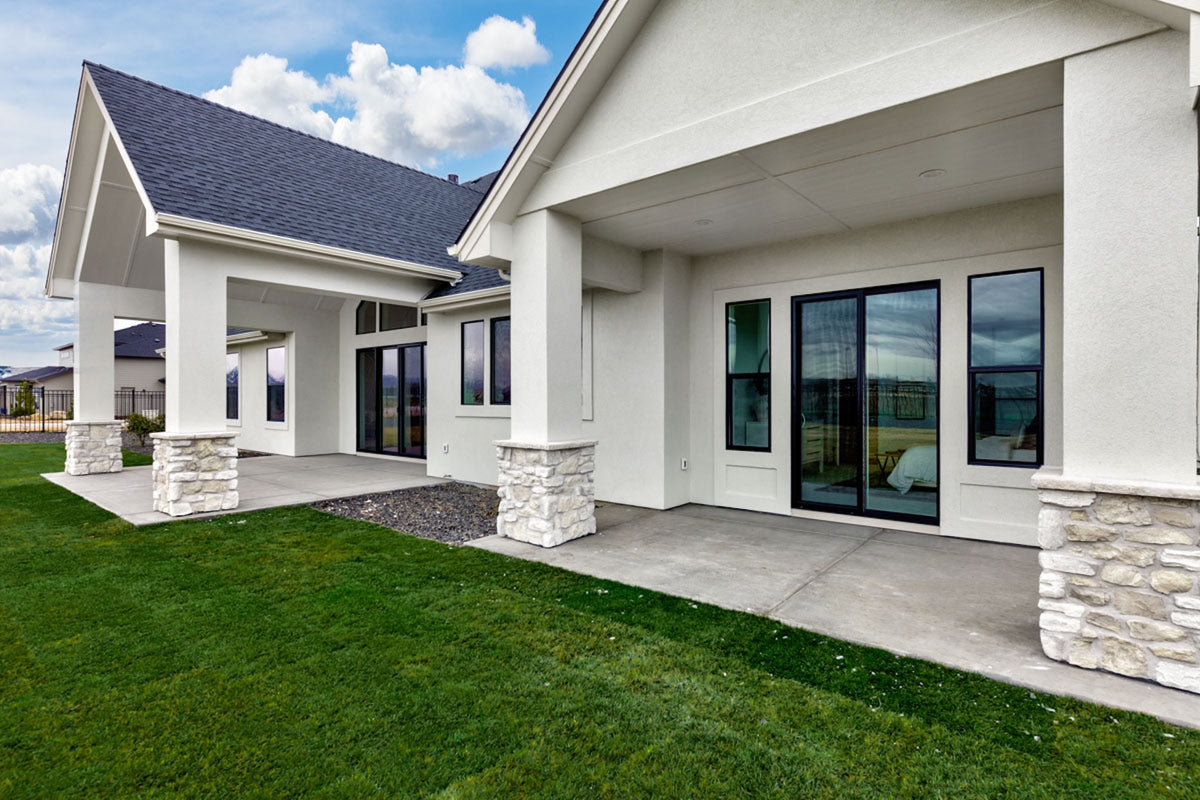 Modern house exterior with a covered porch and large windows.