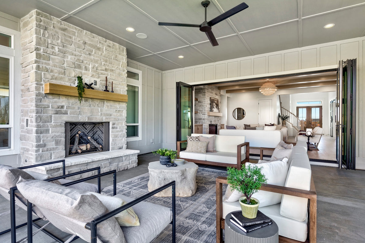 Modern living room with stone fireplace, gray sofa, and wooden coffee table.