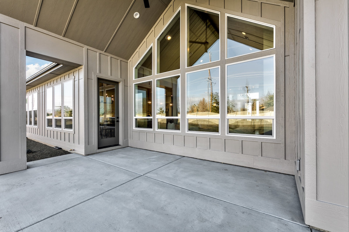 Modern home interior with large windows and concrete floor