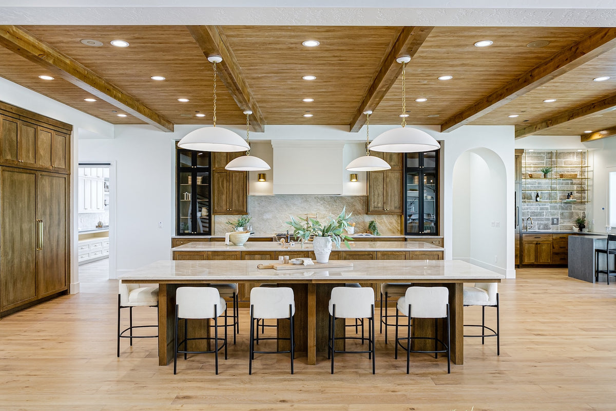 Highland Homes- Parade of Homes -  double island kitchen with Taj Mahal and stone pendants in Eagle, ID. 
