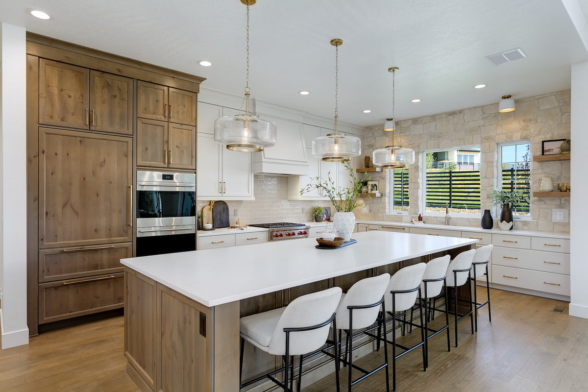 Highland Homes luxury home with white painted and stained wood  cabinets  with stone feature wall in Valnova, Eagle,  ID