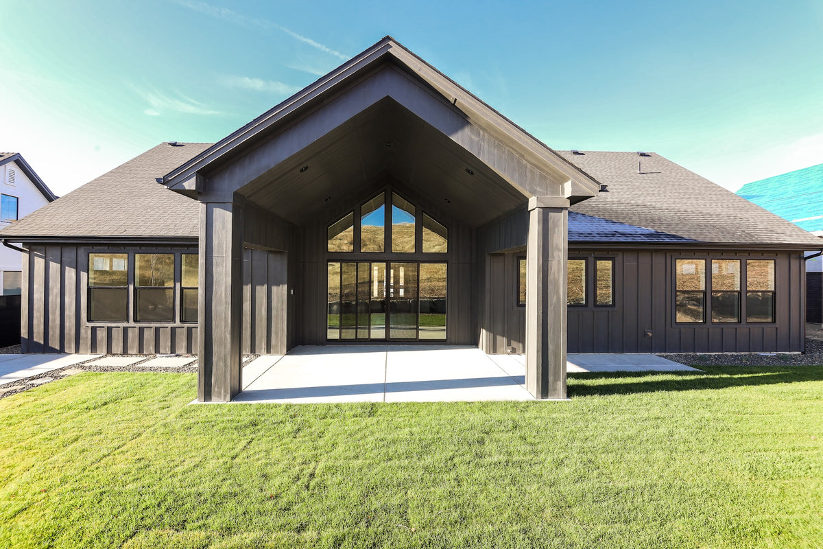 Modern house with a large glass entrance and green lawn